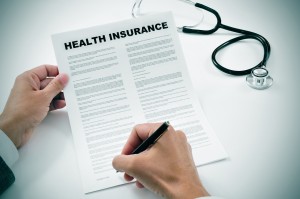 doctor-writing-health-insurance-stethoscope