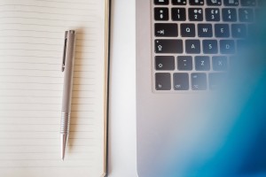 notebook-pen-laptop-taxes-paper-writing