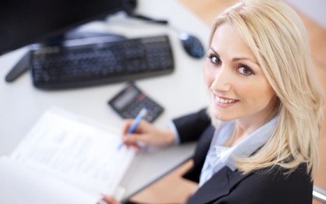 Beautiful businesswoman doing finances in the office